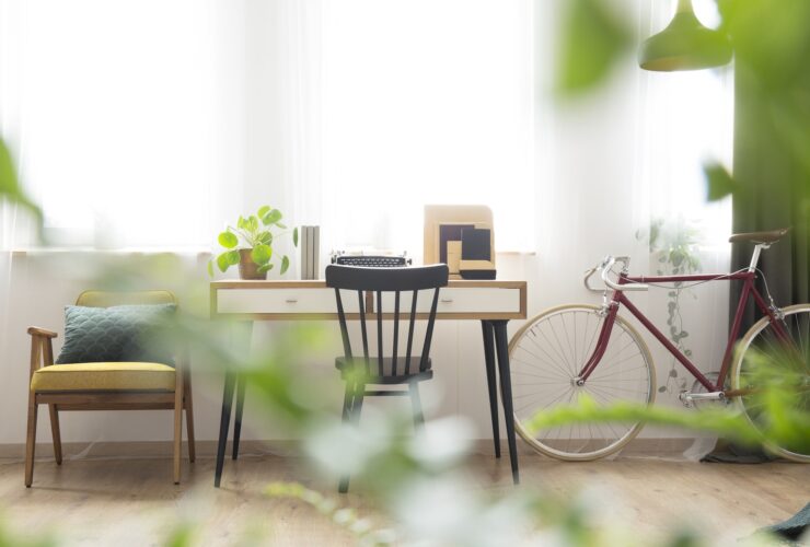 Wooden desk standing by windows