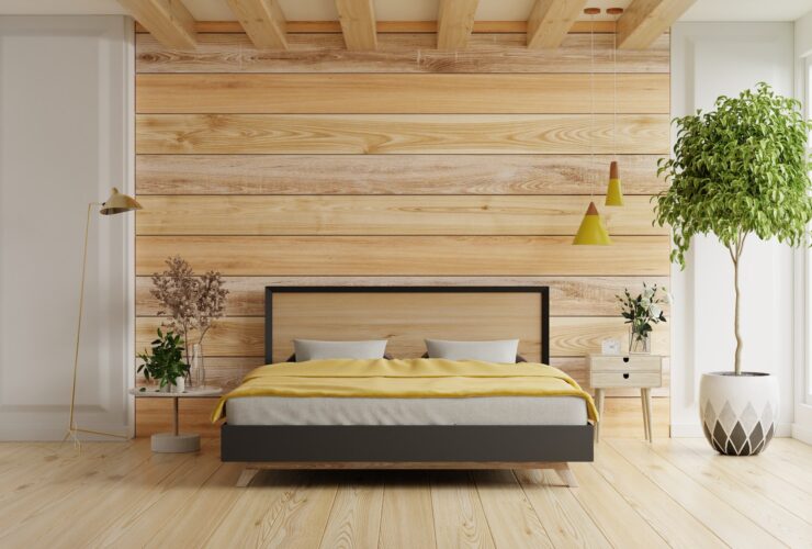 Bedroom interior mockup with gray bed on empty wooden wall background.