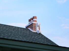 Chimney on house roof closeup blue sky background