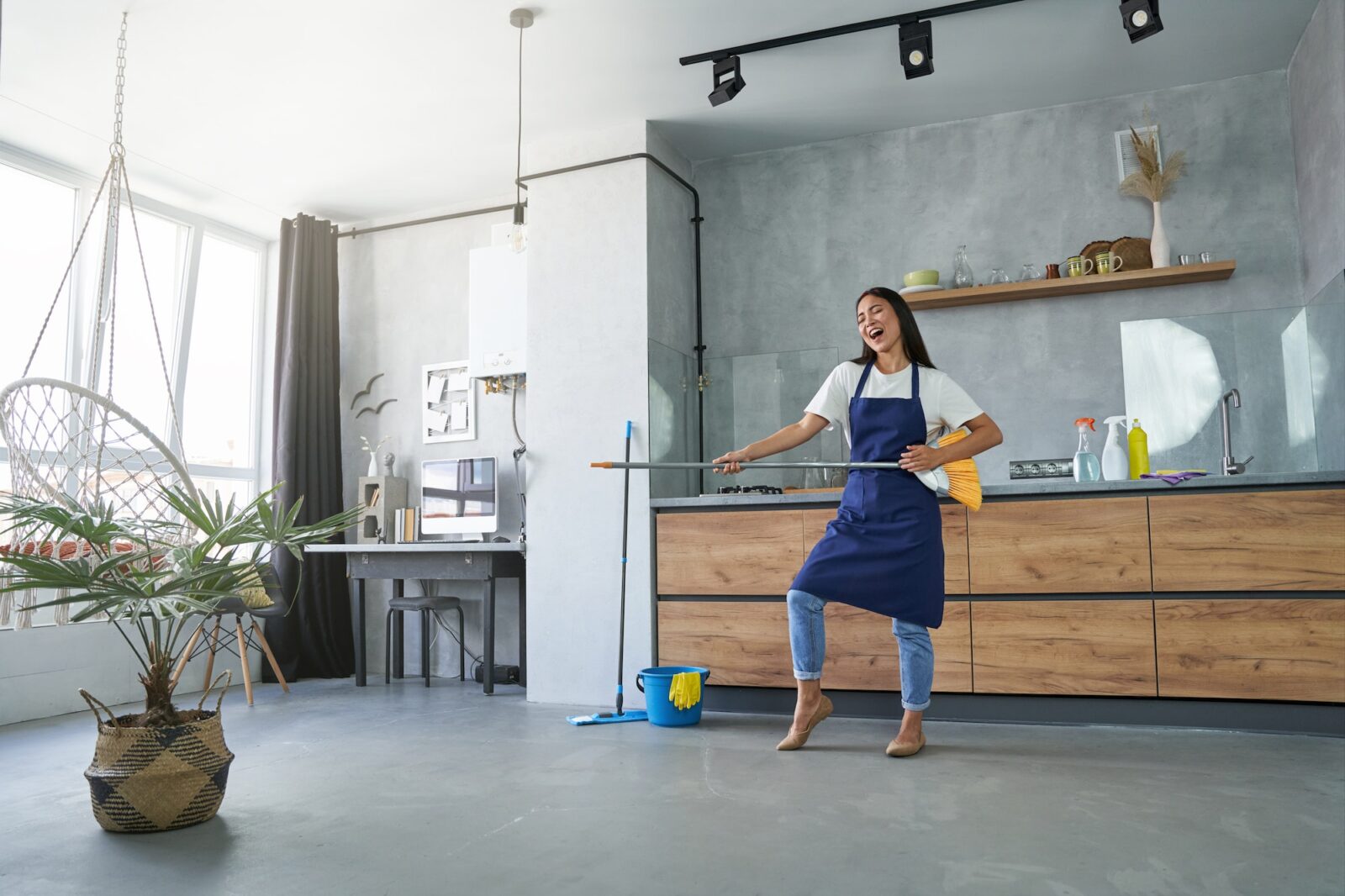 Love the things you do. Full length shot of cheerful young woman, cleaning lady pretending to play