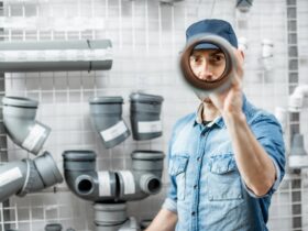 Man choosing pipes in the plumbing shop