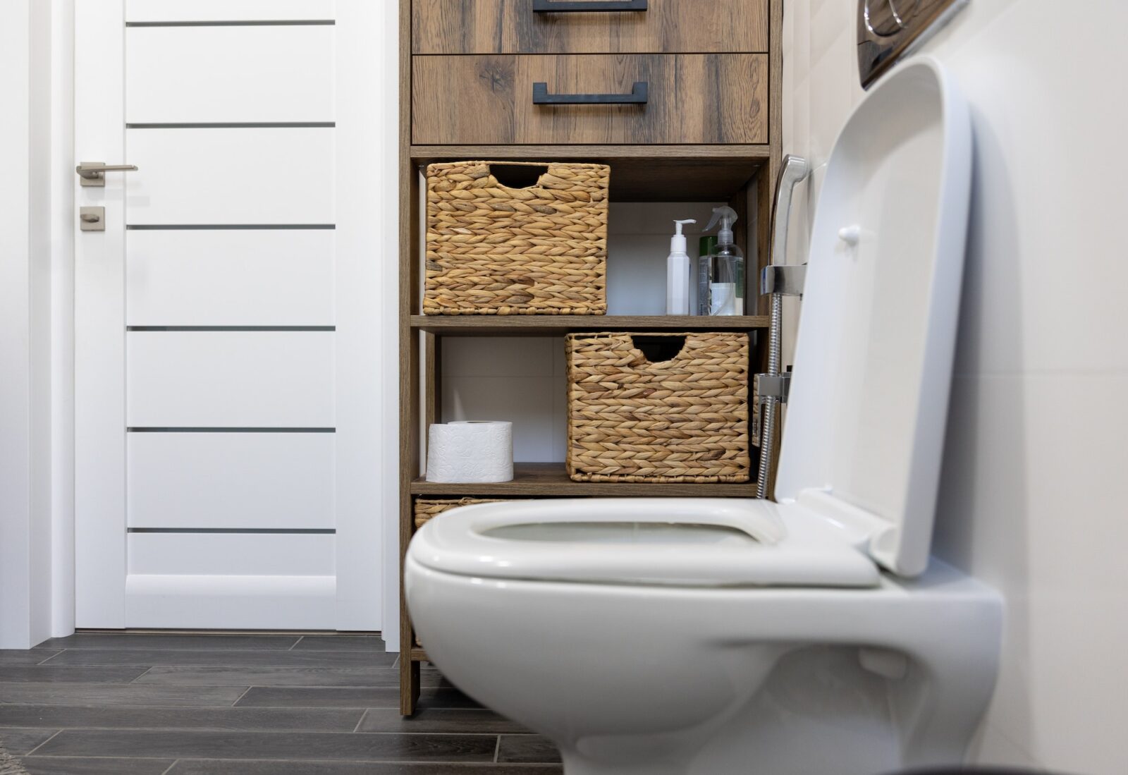 Toilet in the interior of a minimalistic bathroom.