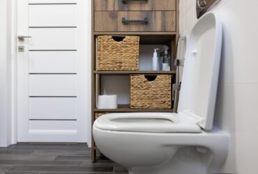 Toilet in the interior of a minimalistic bathroom.