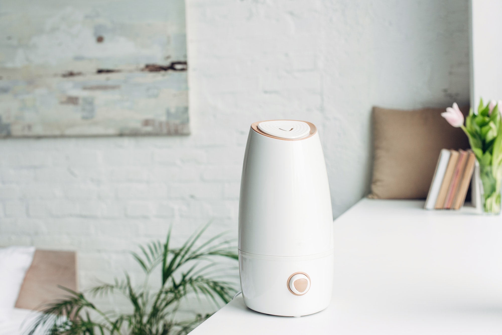white humidifier standing on windowsill at home