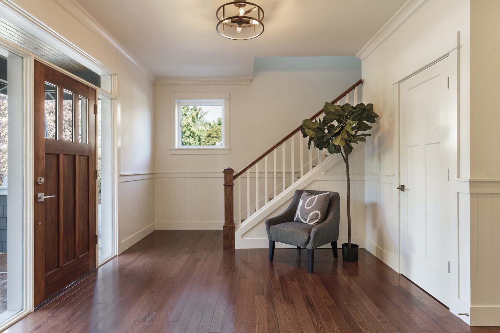 Armchair and tree in house entryway
