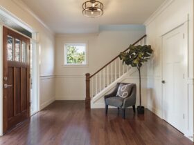 Armchair and tree in house entryway
