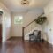 Armchair and tree in house entryway