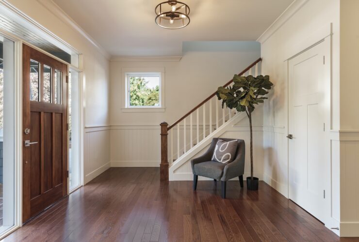 Armchair and tree in house entryway
