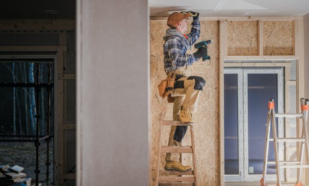 Construction Worker Installing Drywall Ceiling Elements