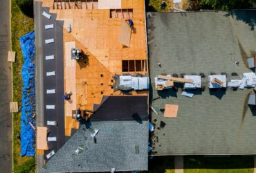 Construction worker on renovation roof the house installed new shingles