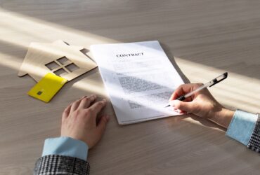 contract for the sale of a house.Home Mortgage Agreement, Real Estate Concept.symbol, wooden house