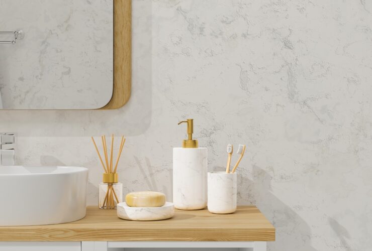 Modern bathroom interior with vessel sink, diffusers, soap, toothbrush, shampoo on wooden countertop