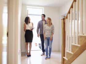 Realtor Showing Young Couple Around Property For Sale