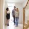 Realtor Showing Young Couple Around Property For Sale