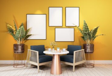 Stylish interior design of dining room with table chair, tropical plant in ceramic pot