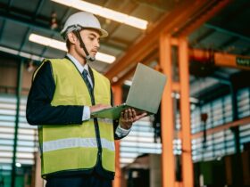 Businessman engineer using software virtual reality in laptop to monitoring machine in real time.
