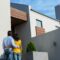Happy Hispanic couple standing and looking at the new house