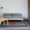 Modern minimalist living room interior mock up with white sofa wooden furniture, gray living room in