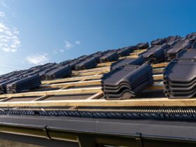 Roof ceramic tile arranged in packets on the roof on roof battens. Preparation for laying roof tiles