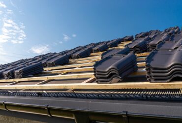 Roof ceramic tile arranged in packets on the roof on roof battens. Preparation for laying roof tiles