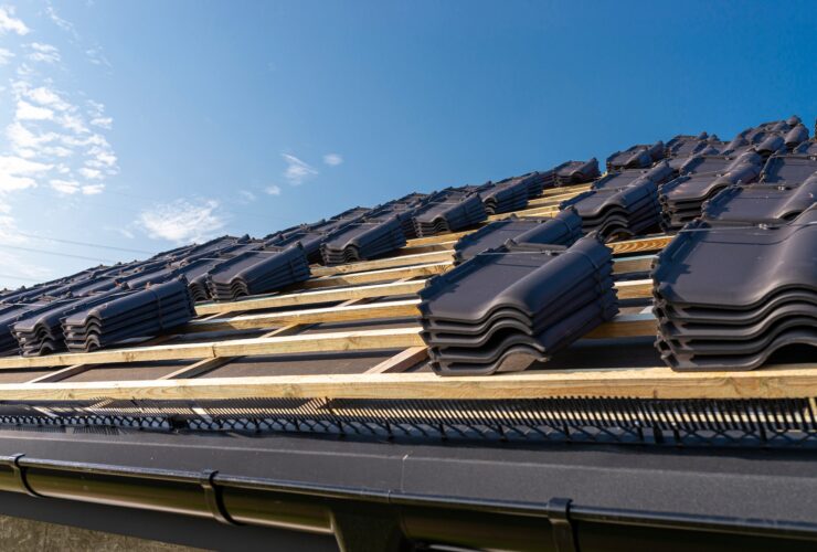 Roof ceramic tile arranged in packets on the roof on roof battens. Preparation for laying roof tiles