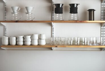 Shelves with glasses and coffee makers