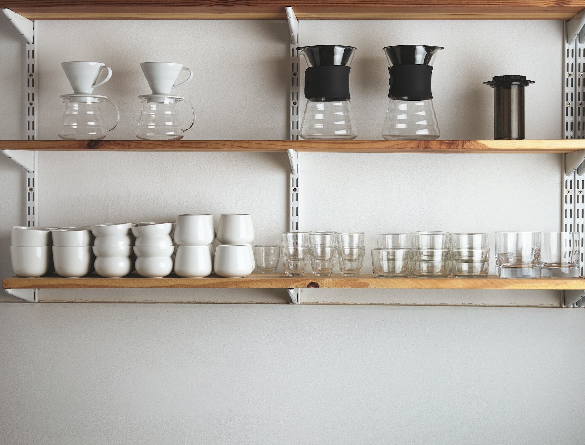 Shelves with glasses and coffee makers