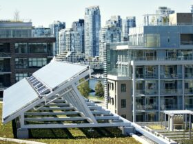 Solar Panel On Field By Buildings In City
