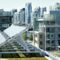 Solar Panel On Field By Buildings In City