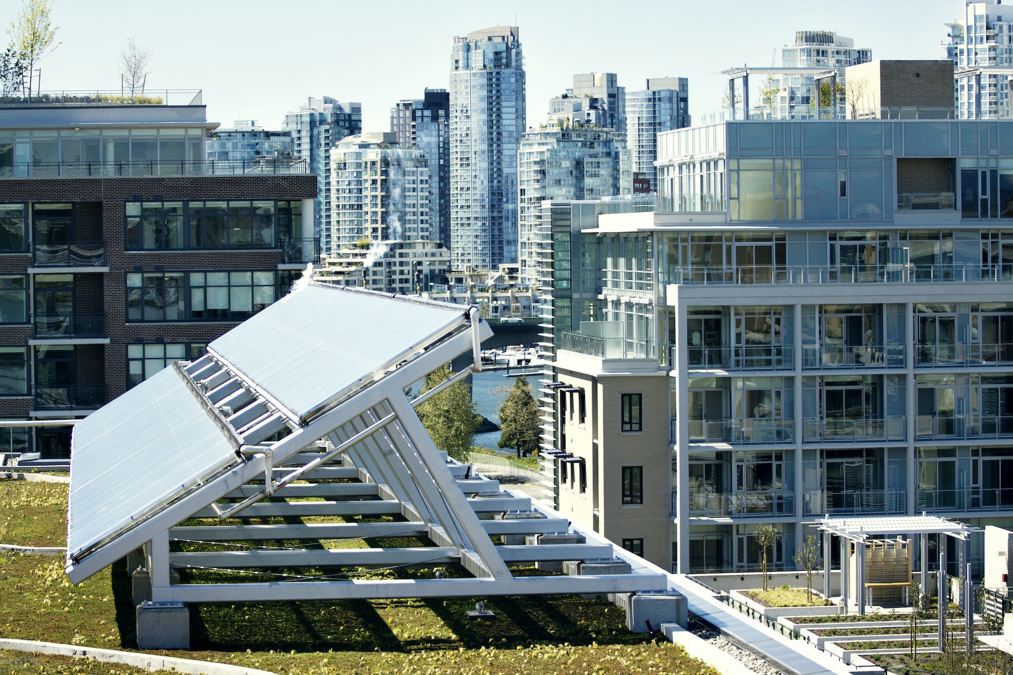 Solar Panel On Field By Buildings In City