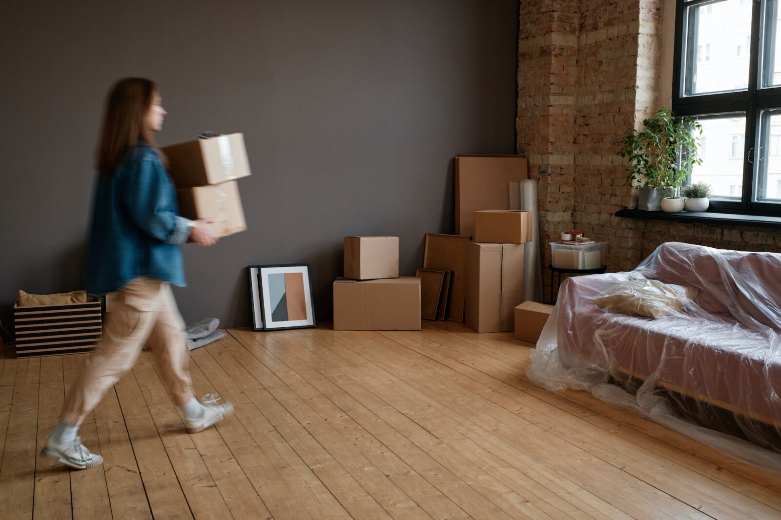 Woman Bringing Boxes Into To New House