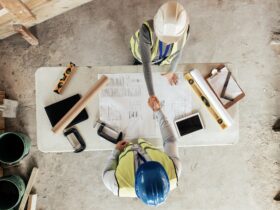 Architect, handshake and thank you for construction, blueprint and collaboration on building design