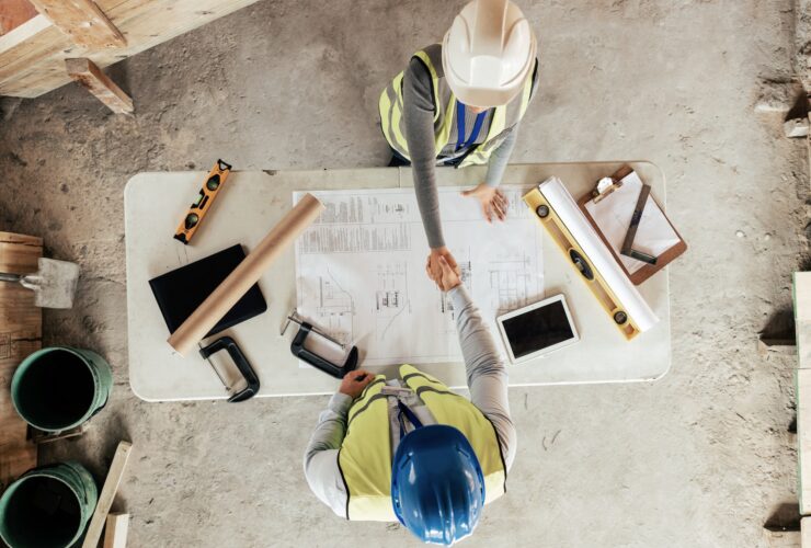 Architect, handshake and thank you for construction, blueprint and collaboration on building design