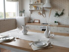 Modern bright scandi kitchen with decor and served table with dishes and plates