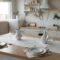 Modern bright scandi kitchen with decor and served table with dishes and plates