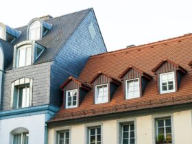 Roofs of old houses with roof windows and orange roof tiles in German city
