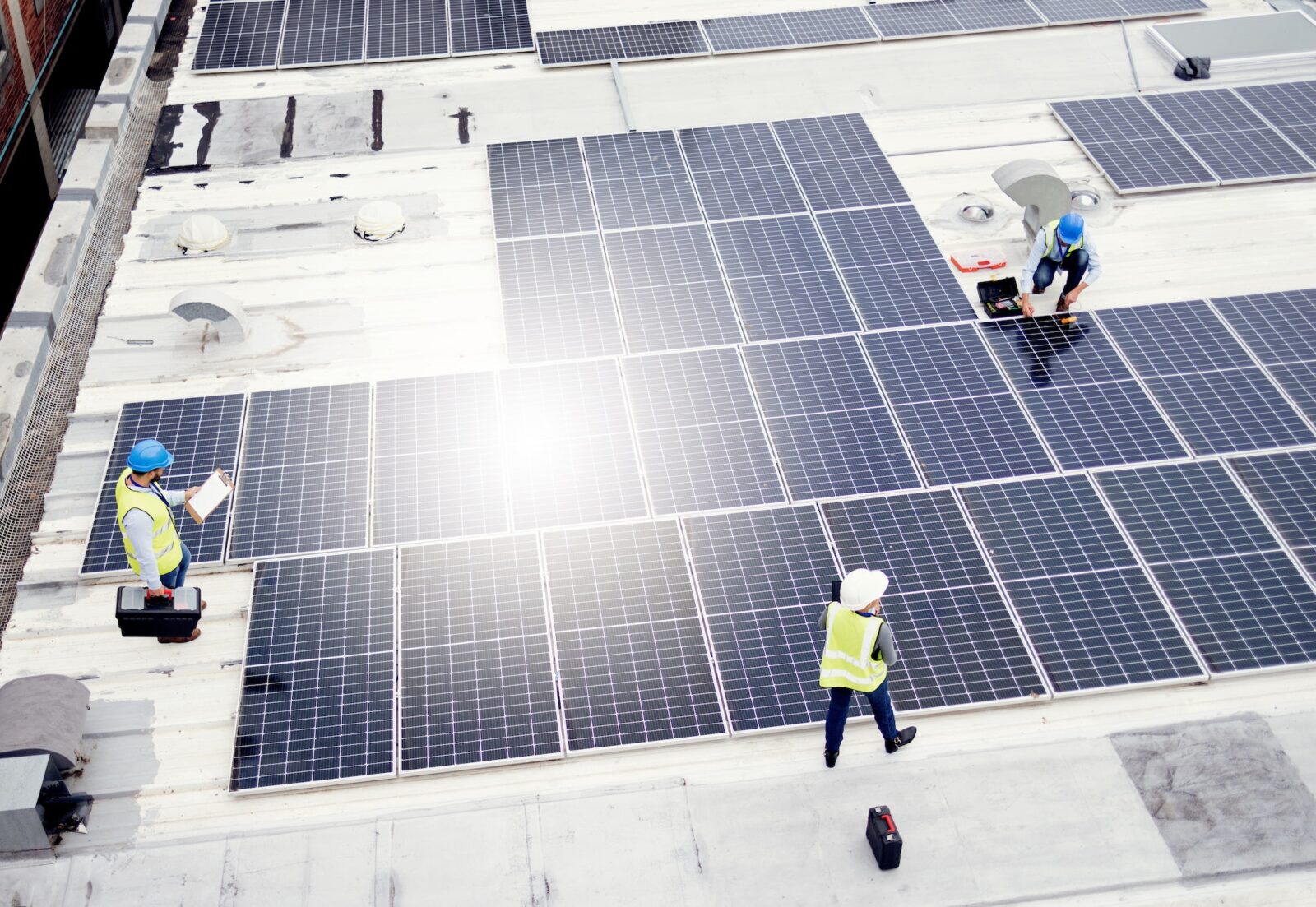 Solar energy, construction and employees building solar panels in collaboration for sustainability,