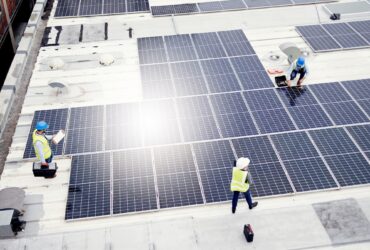 Solar energy, construction and employees building solar panels in collaboration for sustainability,