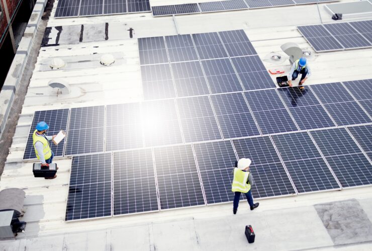 Solar energy, construction and employees building solar panels in collaboration for sustainability,