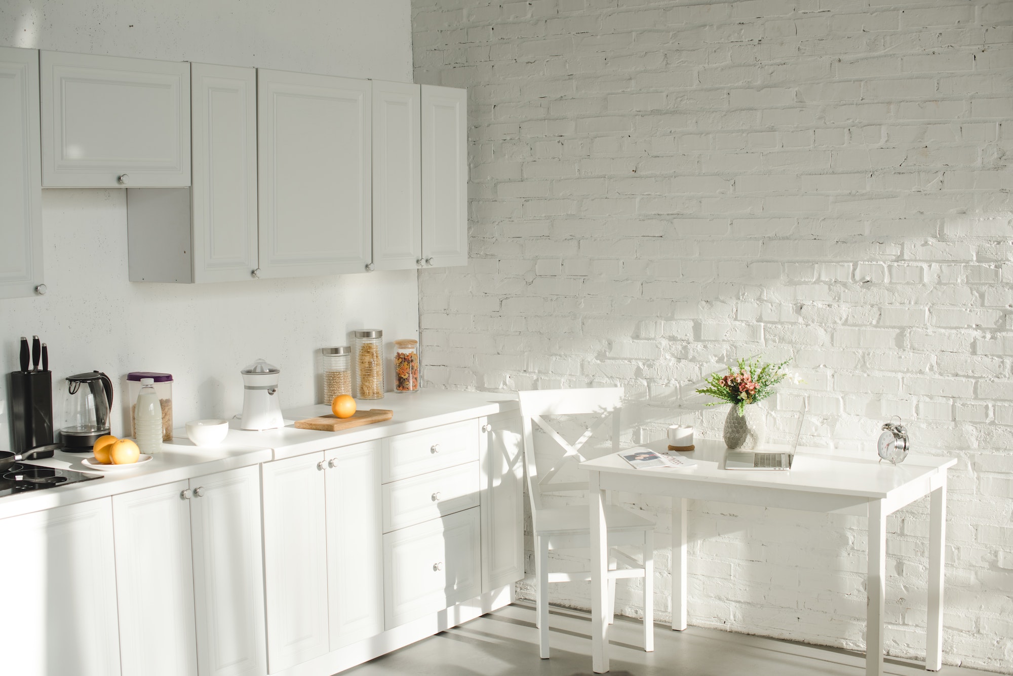 sunlight in white modern kitchen with cooking utensils