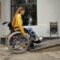 Disabled student in wheelchair at the ramp in cafe