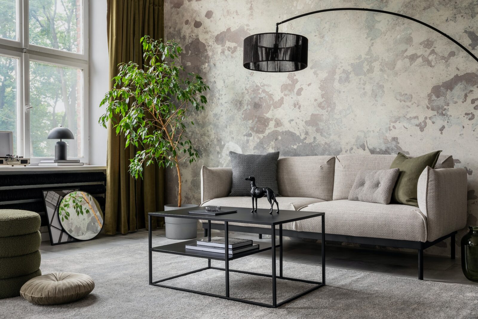 Industrial and loft living room interior with concrete wall, gray sofa, modern armchair,