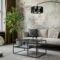 Industrial and loft living room interior with concrete wall, gray sofa, modern armchair,