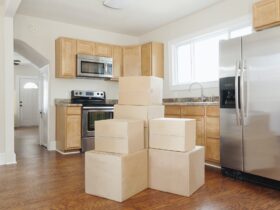 Moving house, relocation, cardboard boxes piled up in a house fitted kitchen