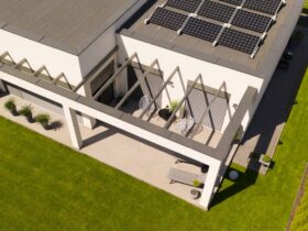Top view of modern suburban house and green grass in the garden