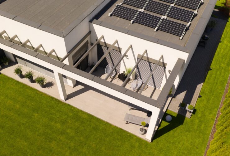 Top view of modern suburban house and green grass in the garden