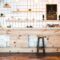 wooden brown bar counter with plants and cupcakes, drawing on shelf in coffee house
