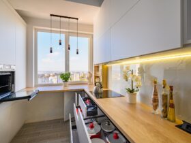 A sleek white kitchen with drawers extended