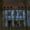 Beautiful and classy ornamented steel fence gate to an impressive old big white house with garden