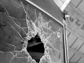 Broken Glass: Monochromatic image of shattered windshield of vintage car in old garage.